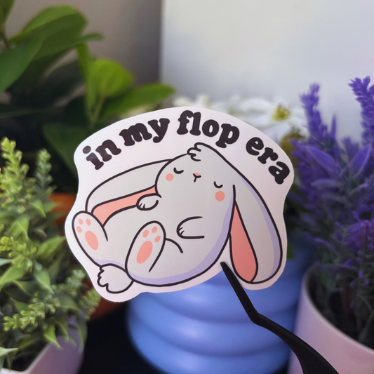 White sticker with a sleeping bunny and the text "in my flop era".