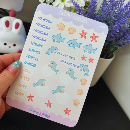 Ocean-themed planner sticker sheet with sharks, shells, starfish, and text labels.