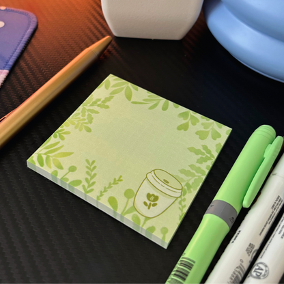 A stack of green sticky notes with a matcha tea cup and leafy border design.