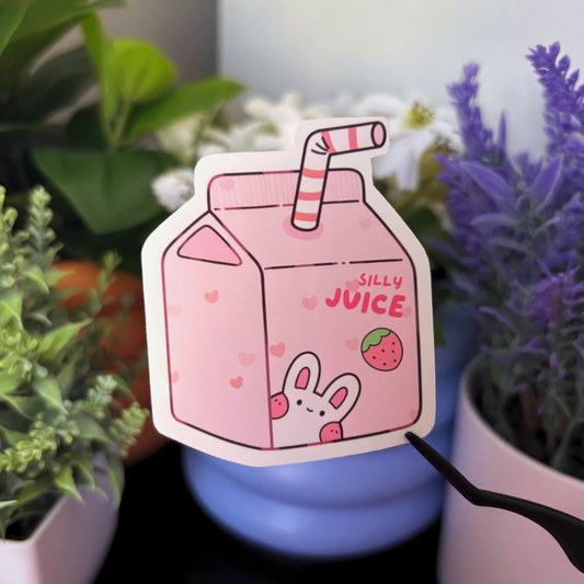 A pink juice box sticker with a bunny, strawberry, and the words "Silly Juice".